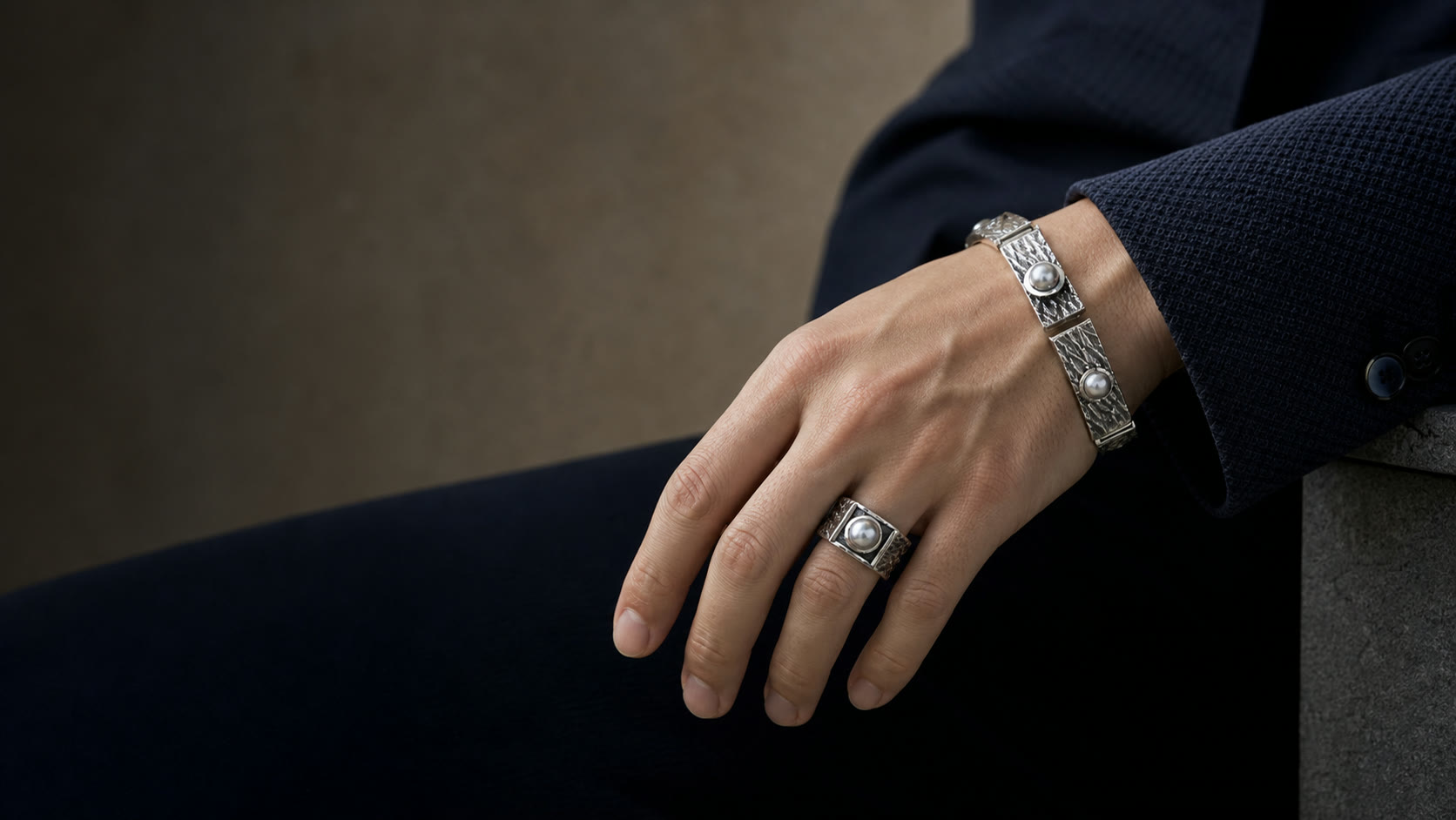 Bis SPIRA matching silver pearl ring and bracelet styled on a younger male hand