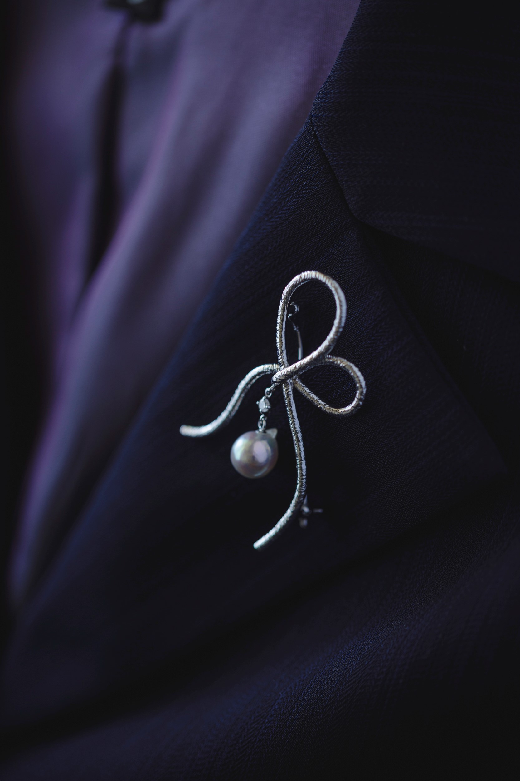 Pearl brooch placed on soft silk