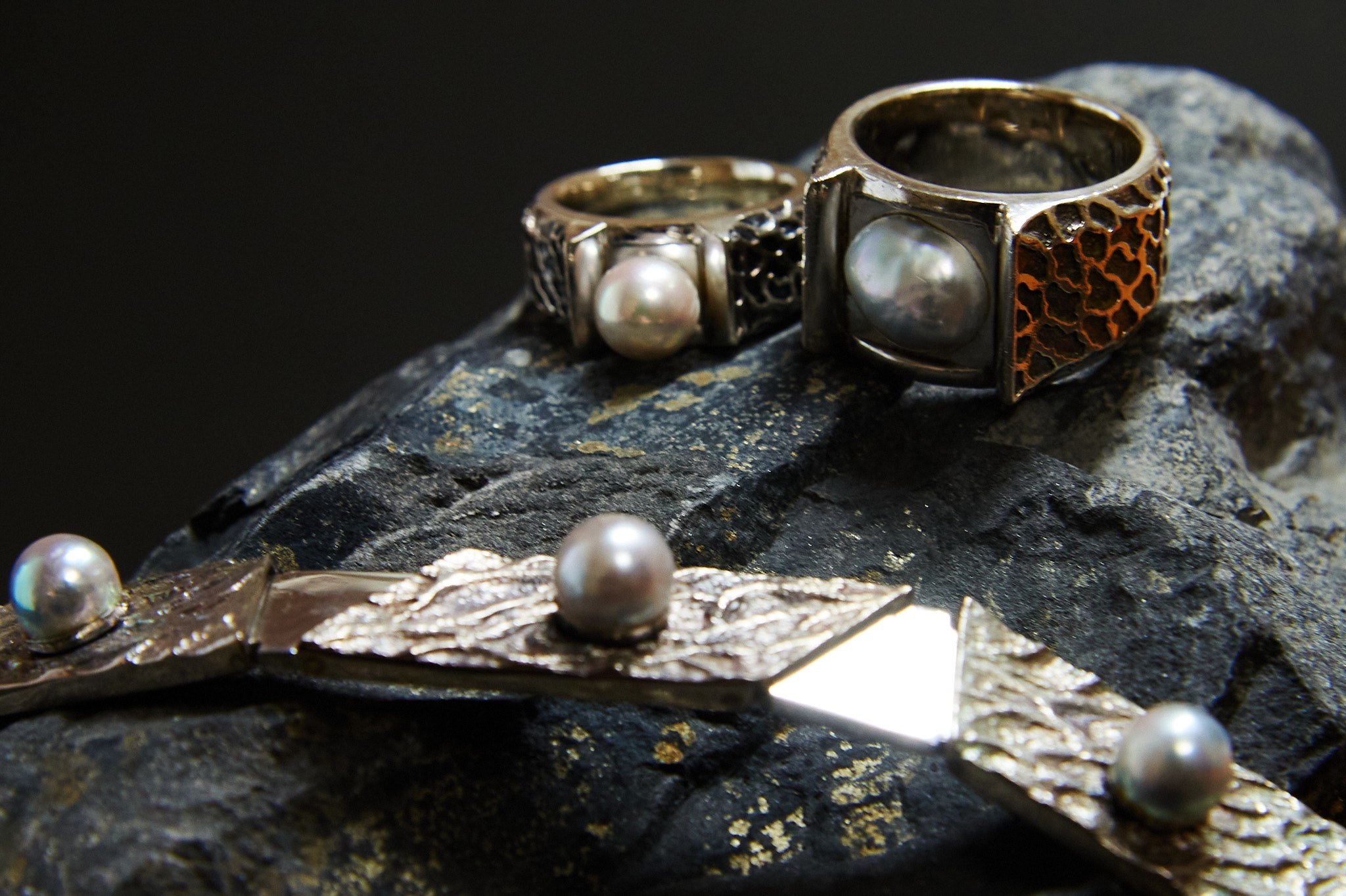 AK design rings with natural Akoya pearls arranged on dark stone