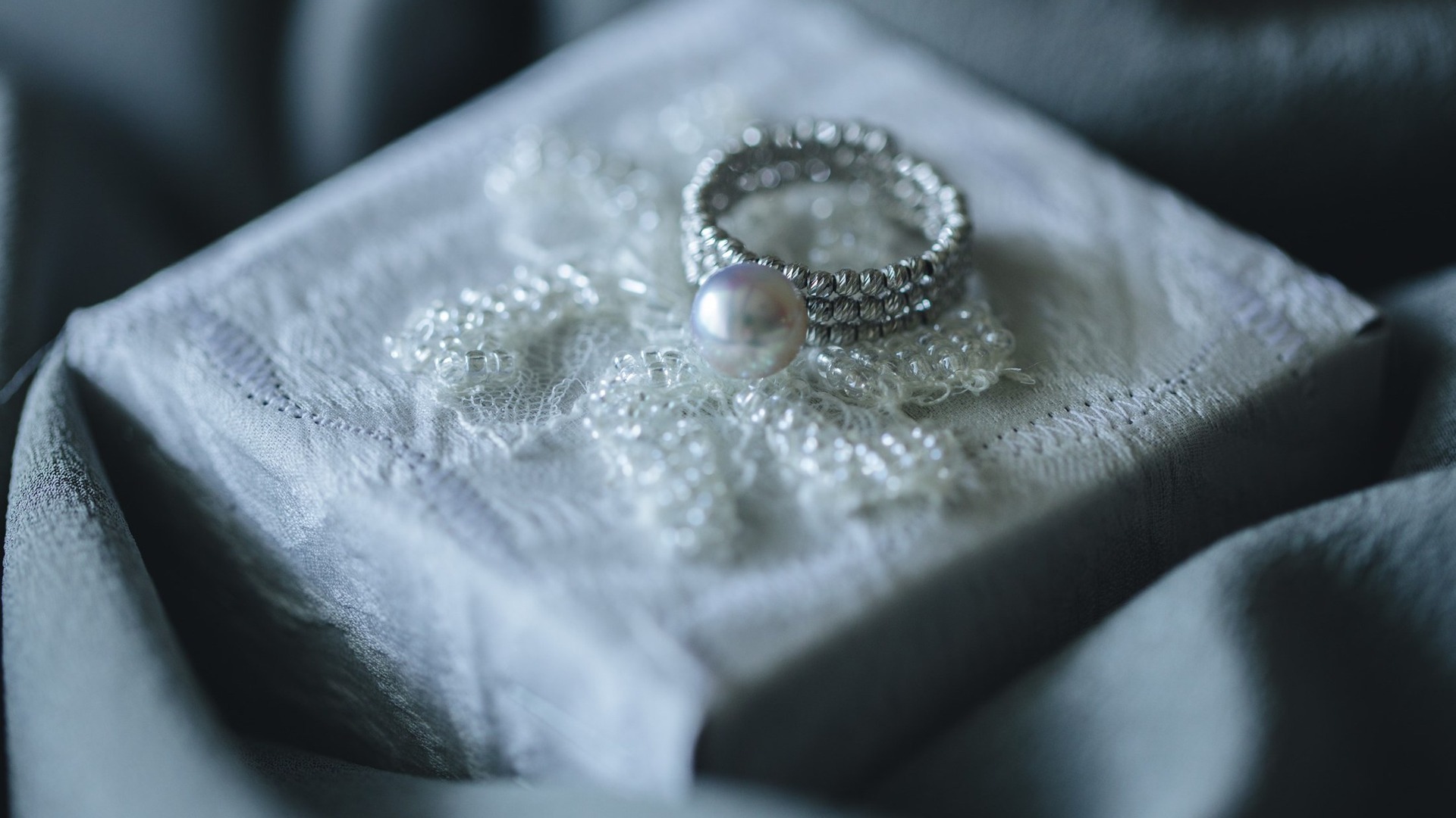 Pearl ring on a lace-lined jewelry display