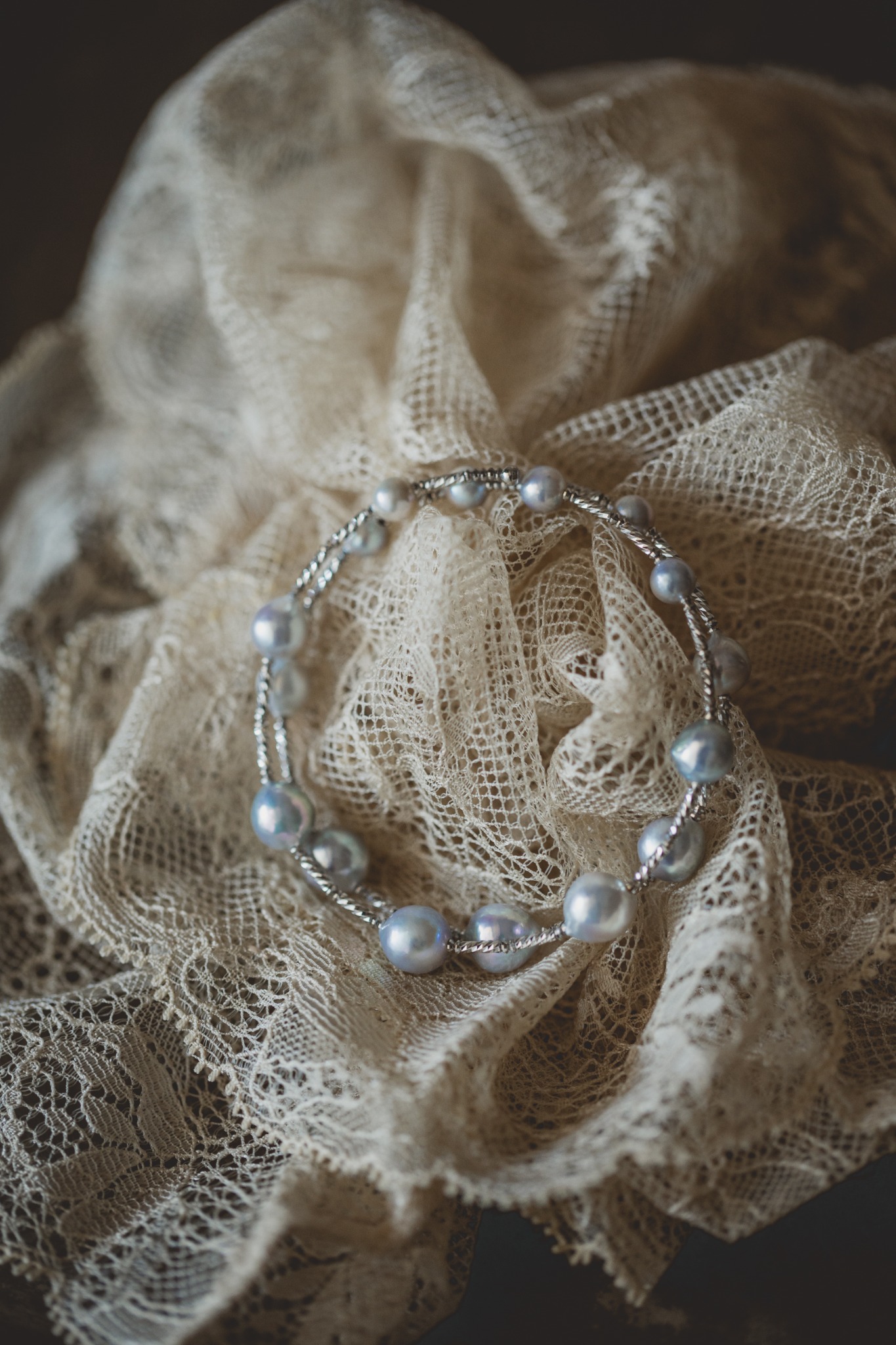 Double-line Akoya pearl bangle on antique lace