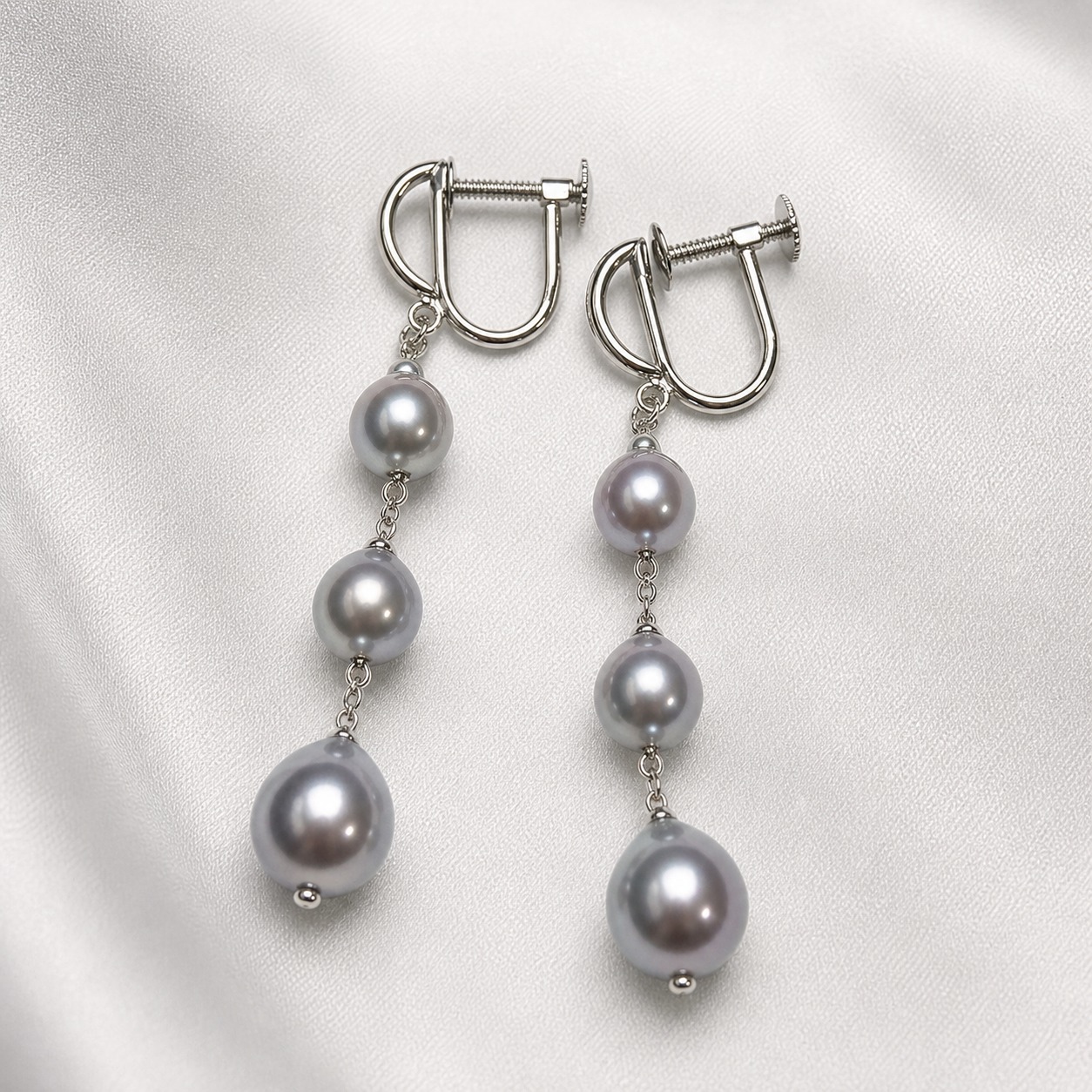 Gray baroque Akoya pearl earrings on white satin